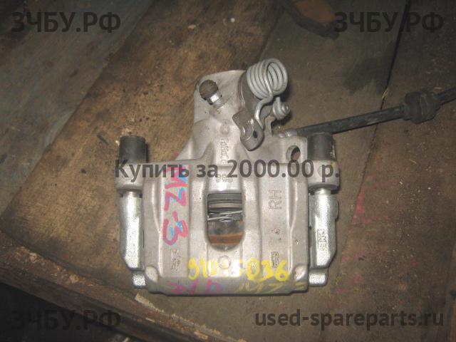 Mazda 3 [BK] Суппорт задний правый (в сборе со скобой)