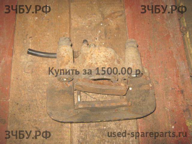 Mazda 323 [BA] Суппорт передний левый (в сборе со скобой)