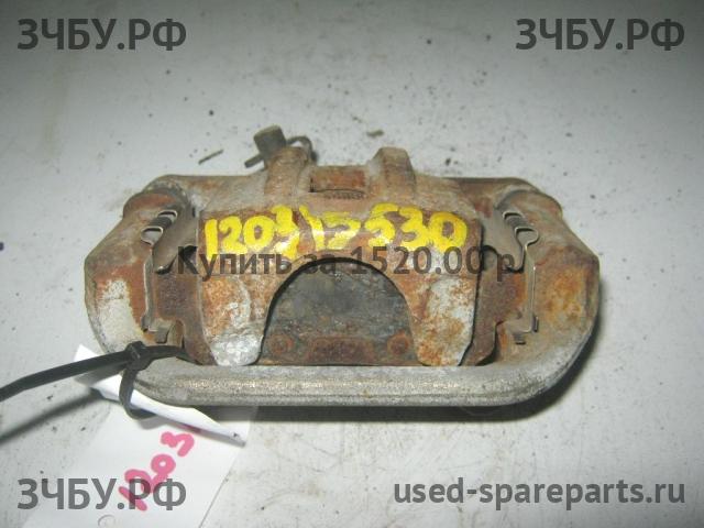 Mazda 323 [BA] Суппорт задний левый (в сборе со скобой)