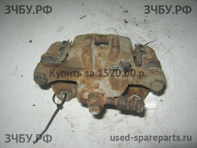 Mazda 323 [BA] Суппорт задний левый (в сборе со скобой)