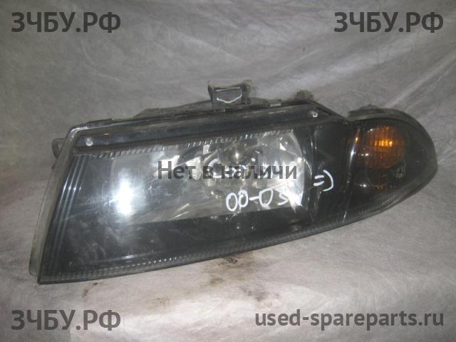 Mitsubishi Carisma (DA) 2000-> Фара левая